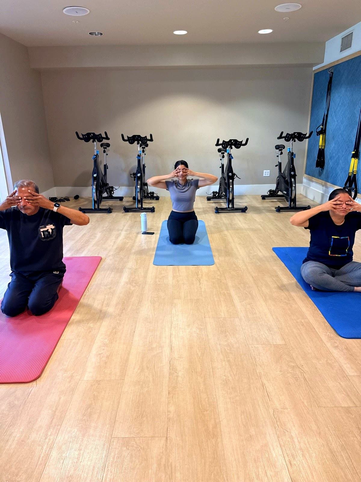 Leading a small group meditation class in a bright studio.